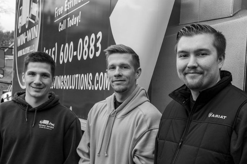 3 owners of WinWin Moving Solutions standing in front of truck